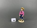 a close up of a figurine of a man with a hat and a cane