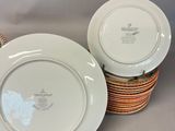two white plates are stacked on top of each other on a table