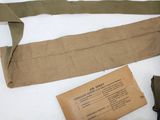 a brown belt with a tag on it next to a brown bag