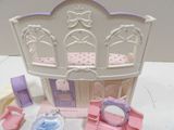 a doll house with furniture and accessories on the table