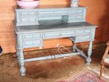 a blue desk with a mirror on top of it