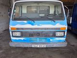 an image of a blue and white van parked in a garage