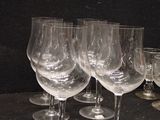 several empty wine glasses are lined up on a table