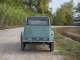a green truck that is parked on the side of the road
