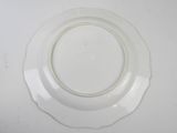 a white plate with a white rim on a white table