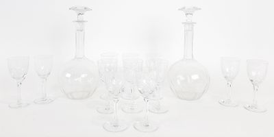a group of wine glasses and a decanter on a table
