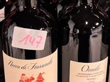 several bottles of wine are lined up on a shelf in a store