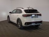 the rear end of a white volkswagen suv parked in a showroom