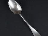 a spoon that is sitting on a black surface