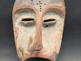 an image of a clay mask on a black background