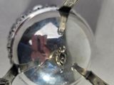 a reflection of a person in a mirror on a spoon