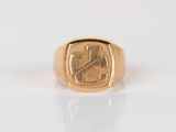a close up of a gold ring with a cross on it