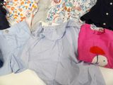 a lot of clothes that are laying out on a bed