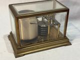 a glass case with a clock inside of it on a table
