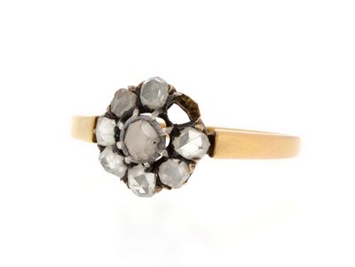 a close up of a gold and diamond ring on a white background