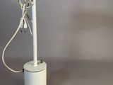 a white table lamp with a cord attached to it