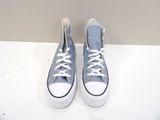 pair of blue and white converses sitting on a white surface