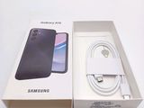 a box with a phone and a charger in it