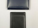 a black wallet and a blue wallet sitting on top of each other