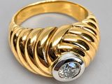 a close up of a gold ring with a diamond in the center