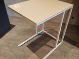 a small table with a white top on a tiled floor