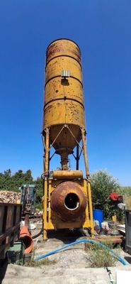 a large yellow water tower sitting in the middle of a yard