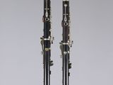 a pair of black and white clarinets sitting on top of a table