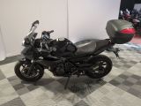 a motorcycle that is parked on a checkered floor