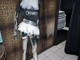 a mannequin dressed in a white tutu and a black t - shirt