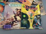 many comic books on a table with a gray background