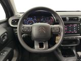 the interior of a car with a steering wheel and dashboard controls