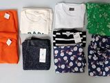 many different types of clothing laid out on the table