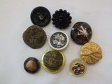a lot of buttons that are sitting on a table