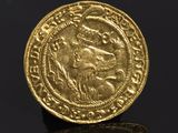 a gold coin with an image of a man on a horse