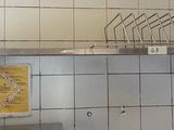 a metal shelf that has a bunch of knives on it
