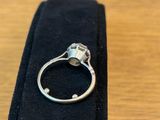 a close up of a ring on a black case on a table