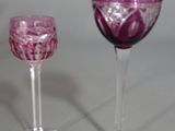 two wine glasses sitting next to each other on a table