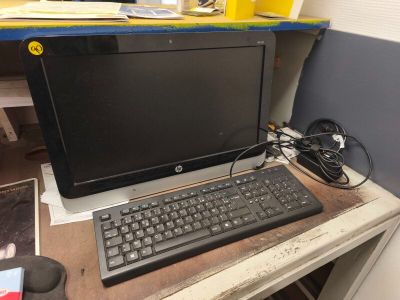 a desktop computer sitting on top of a wooden desk