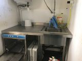 a kitchen with a sink and a dishwasher in it