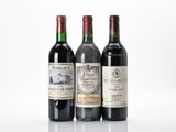 trois bouteilles de vin sont alignées sur une surface blanche
