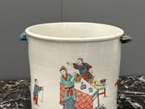 a white bucket with a painting on it sitting on a table