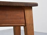 a close up of a wooden table with a drawer underneath it