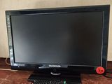 the monitor is on the counter next to the keyboard and mouse