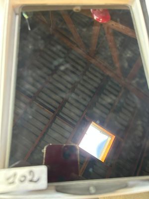 a picture of a window in a room with a red chair