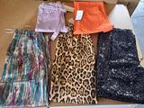 a lot of clothes in a box on the floor
