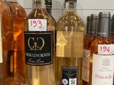 several bottles of wine are lined up on a counter