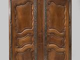 an antique wooden armoire with ornate carvings on the doors