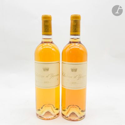 two bottles of wine sitting next to each other on a white surface