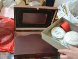 a person holding a box with a microwave inside of it