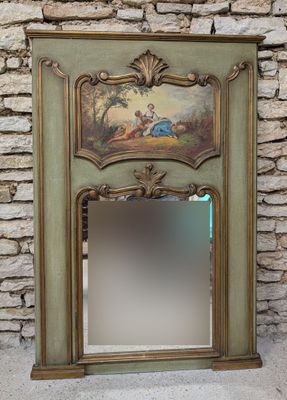 a mirror with a painting on it in front of a stone wall
